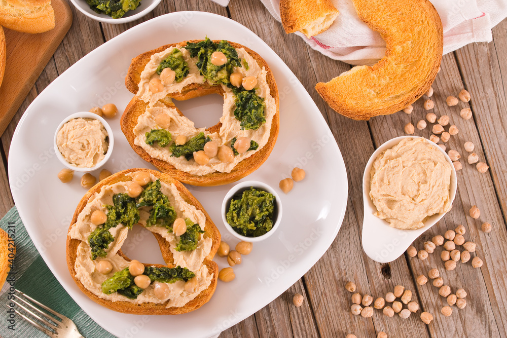 Friselle with turnip tops and hummus. Friselle with turnip tops and hummus.