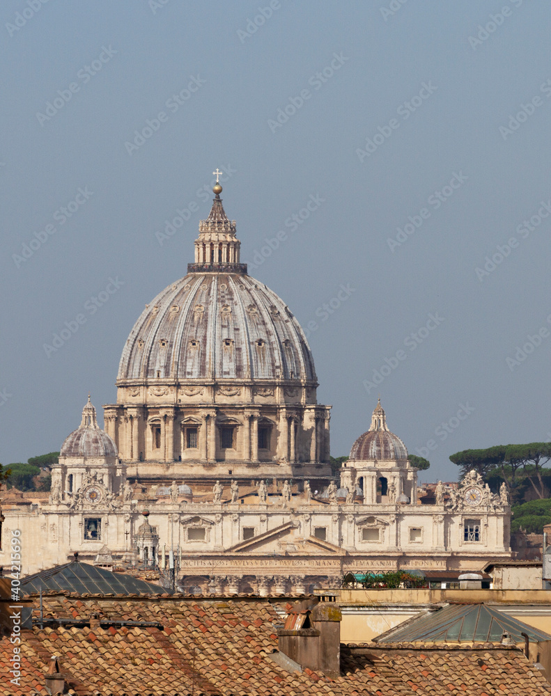 The Papal Basilica of Saint Peter in the Vatican (Basilica Papale di San Pietro in Vaticano), or simply Saint Peter's Basilica seen over city rooftops