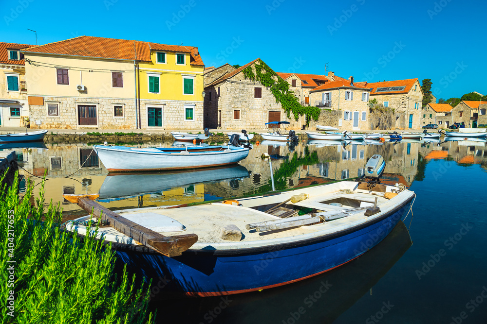 Vrboska mediterranean village with stone houses and moored boats, Croatia