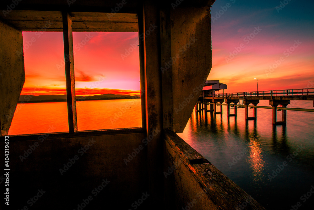 The background of the bridge stretches into the sea, with twilight light in the morning, beautiful colors, sky wallpaper and refreshing surroundings.