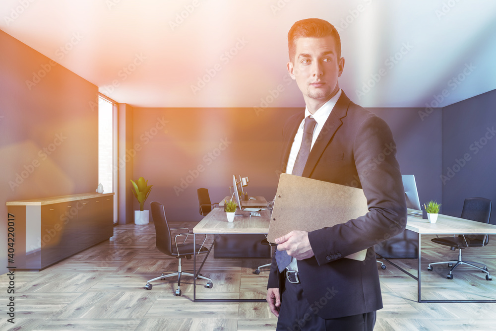 Fototapeta premium Man in gray open space office