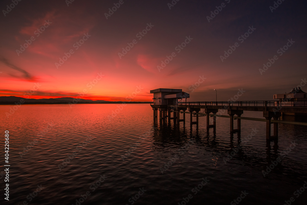 The background of the bridge stretches into the sea, with twilight light in the morning, beautiful colors, sky wallpaper and refreshing surroundings.