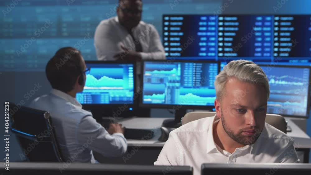 Diverse team of brokers workin in office using workstation and analysis technology. Workplace of professional traders. Global financial markets, business, currency exchange and banking concepts. Diverse team of brokers workin in office using workstation and analysis technology. Workplace of professional traders. Global financial markets, business, currency exchange and banking concepts.