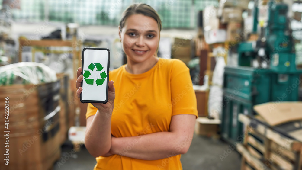 Recycling sign with green arrows on smartphone screen Recycling sign with green arrows on smartphone screen