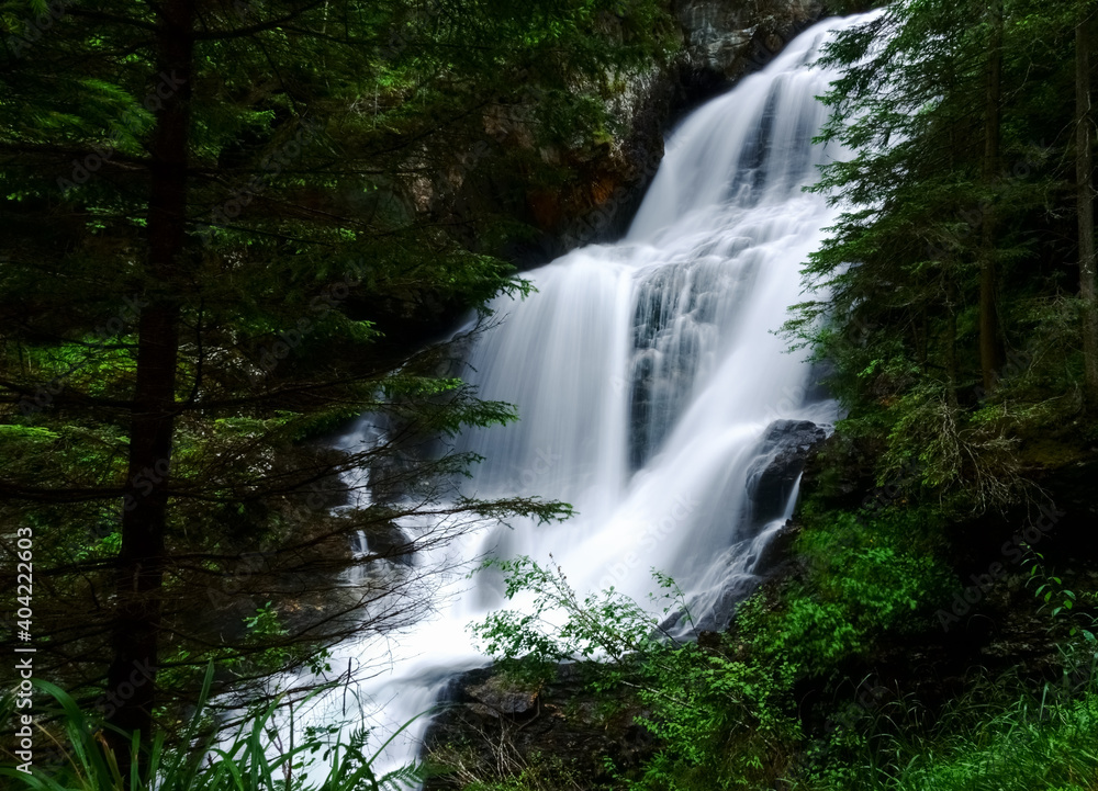 large soft flowing waterfall in the green forest large soft flowing waterfall in the green forest