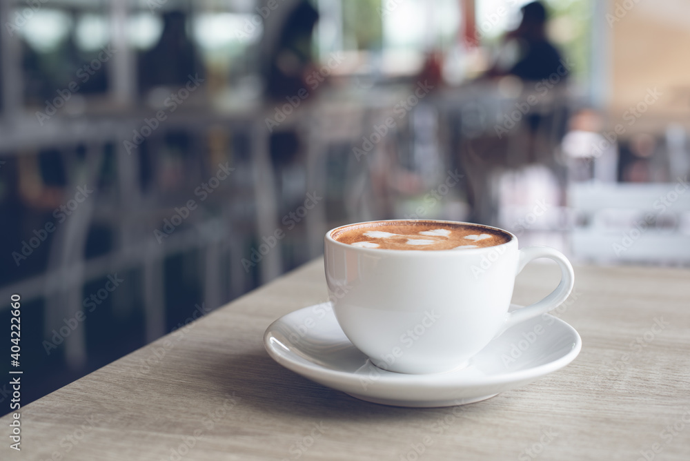 Cup of white porcelain coffee on table in coffee shop Cup of white porcelain coffee on table in coffee shop