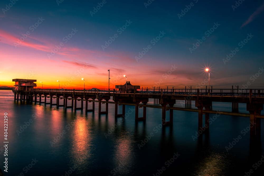 The background of the bridge stretches into the sea, with twilight light in the morning, beautiful colors, sky wallpaper and refreshing surroundings.