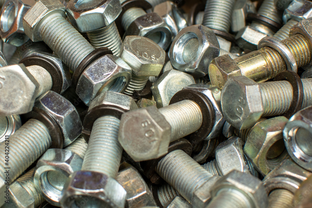 Сlose up of bright and shiny nuts, bolts and washers. Industrial background. Сlose up of bright and shiny nuts, bolts and washers. Industrial background.