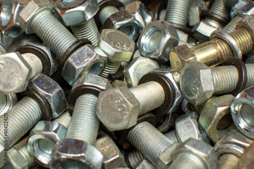 Сlose up of bright and shiny nuts, bolts and washers. Industrial background. 