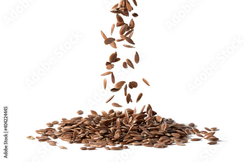 Canvas Print Close up of linseeds or flax seeds falling down in a pile and isolated on white