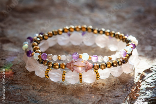 Collection of natural mineral gemstone beads bracletes on natural neutral background photo