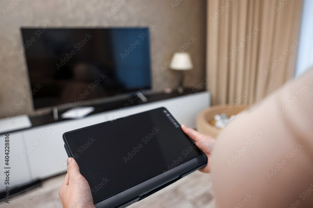 Female hands hold a digital tablet close-up, top view. New technology concept, multimedia.