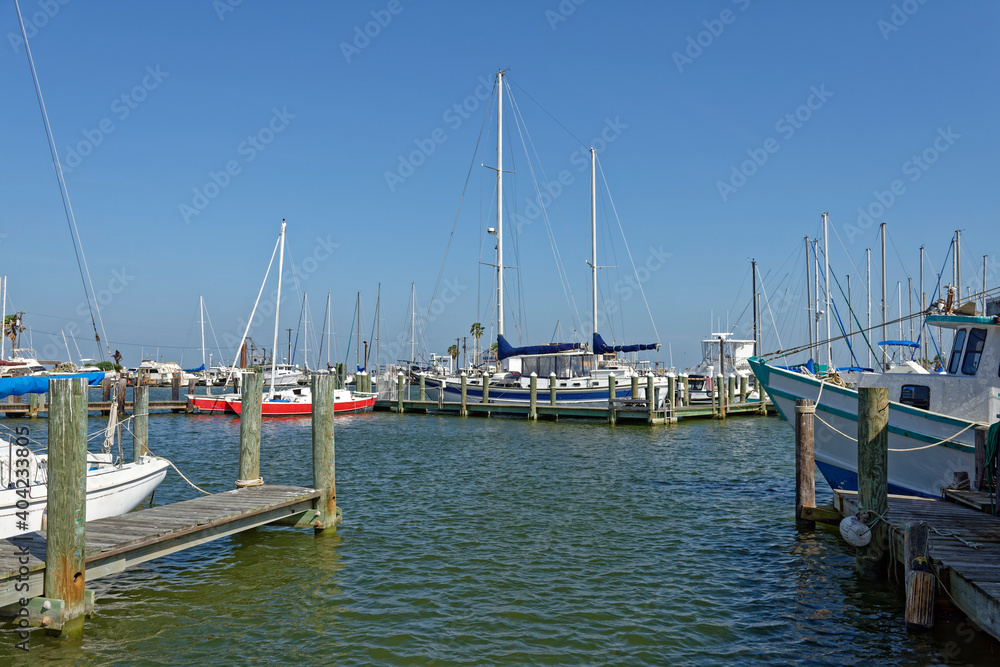 One of the many Marinas around the waterfront of Rockport near to the Gulf Coast in Texas, with its wooden jettyÕs and moored Yachts and Boats.