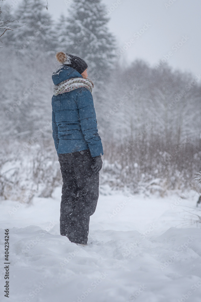 girl walking in the winter forest