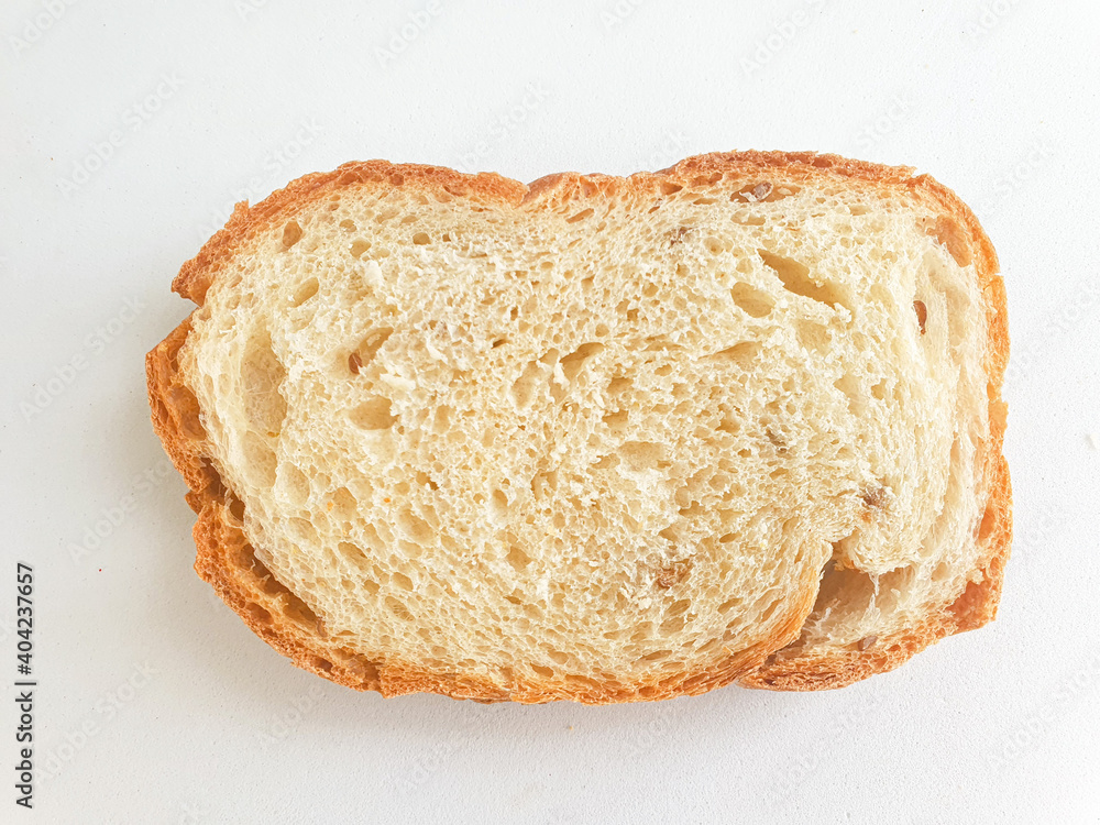 slice of bread. Closeup freshly baked homemade traditional bread on white background. Concept - Cooking at Home. Top view 