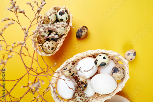 Easter eggs are minimalistically, decorated with dry flowers on yellow background photo