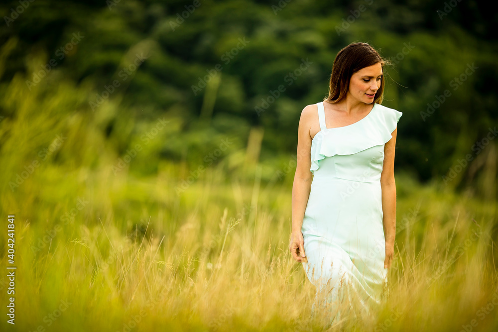 Young pregnant woman relaxing outside in nature Young pregnant woman relaxing outside in nature