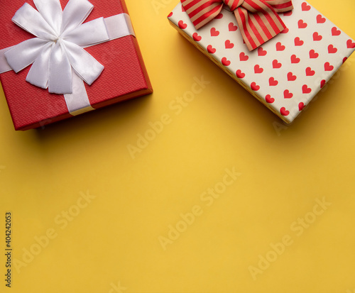 Red and white gift box with on yellow background,flat lay
