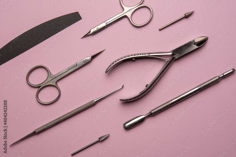 Set of manicure tools and accessories on a pink background. Hardware manicure,Flat lay.