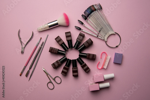 Fototapeta Naklejka Na Ścianę i Meble -  Set of manicure tools and accessories on a pink background. Hardware manicure,Flat lay.