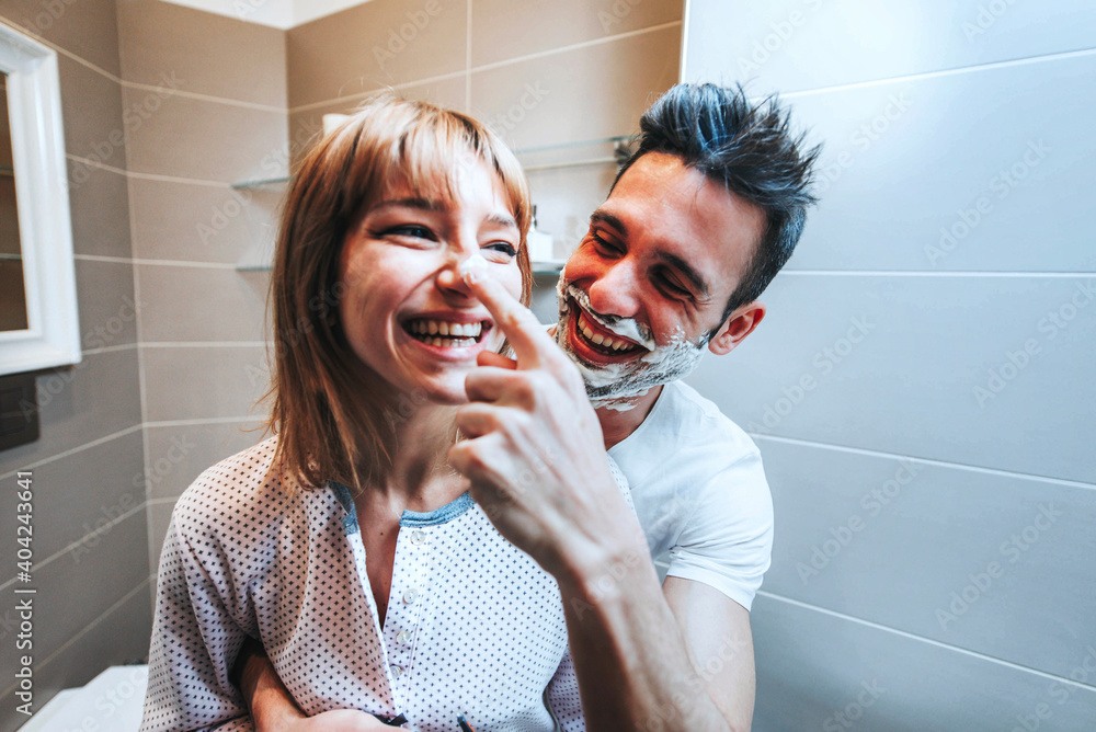 Young couple having fun playing with shaving foam in the bathroom -  Boyfriend and girlfriend enjoying domestic romantic moment together Stock  Photo | Adobe Stock