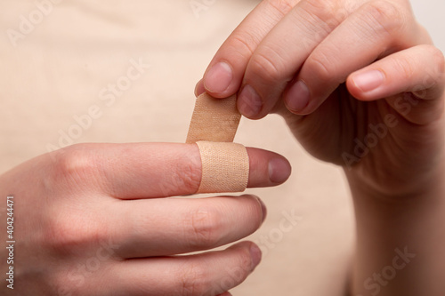 The man seals the wound with adhesive plaster. The medicine. Injury. Wound. Infection. First aid. Pain