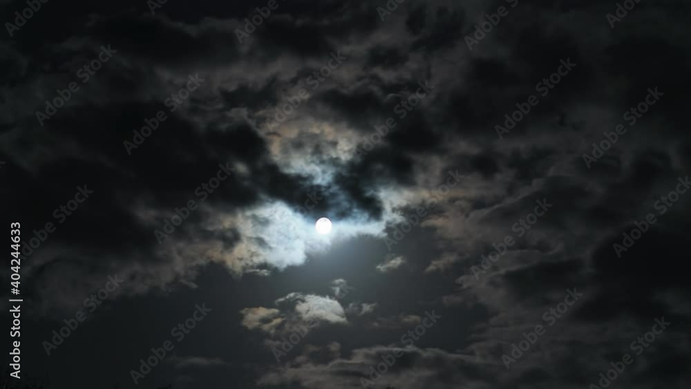 Timelapse epic dark night sky observation. Amazing cumulus clouds move obscuring bright full moon. Starless black sky. Climate ecology. Nightlife, time of werewolves and evil spirits. Cloudscape film Timelapse epic dark night sky observation. Amazing cumulus clouds move obscuring bright full moon. Starless black sky. Climate ecology. Nightlife, time of werewolves and evil spirits. Cloudscape film