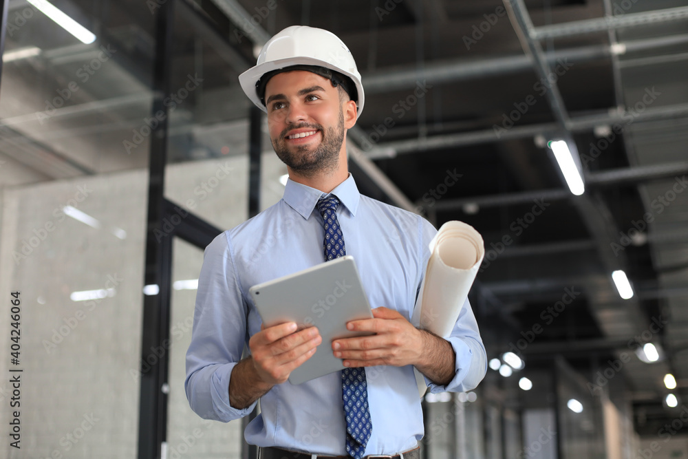 Shot of a engineer using a digital tablet on a construction site. Shot of a engineer using a digital tablet on a construction site.