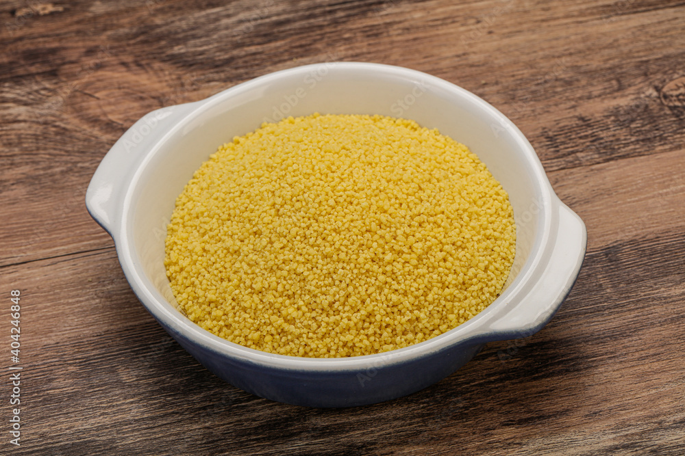 Raw cous cous heap in the bowl Raw cous cous heap in the bowl