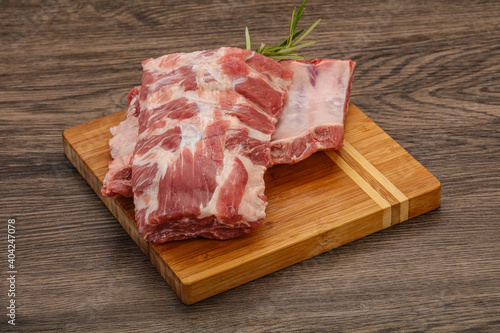 Raw pork ribs served rosemary