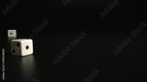 Childrens board games concept. Thrown dices on black background, close up. White Dices rolling. high quality.