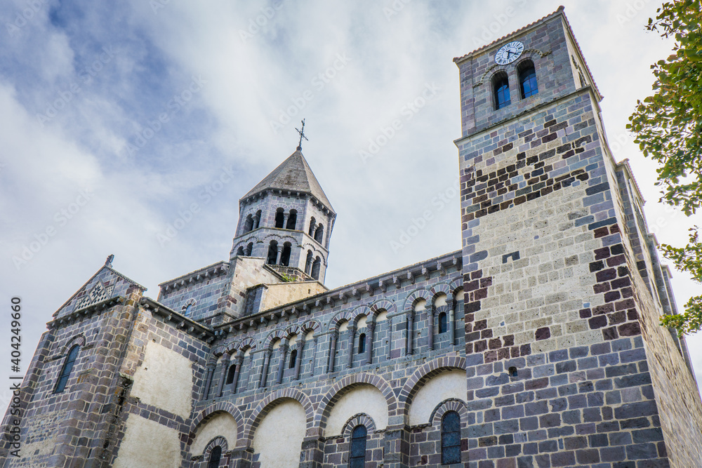view of the 12th century romanesque church of the small town of Saint Nectaire in Auvergne, France