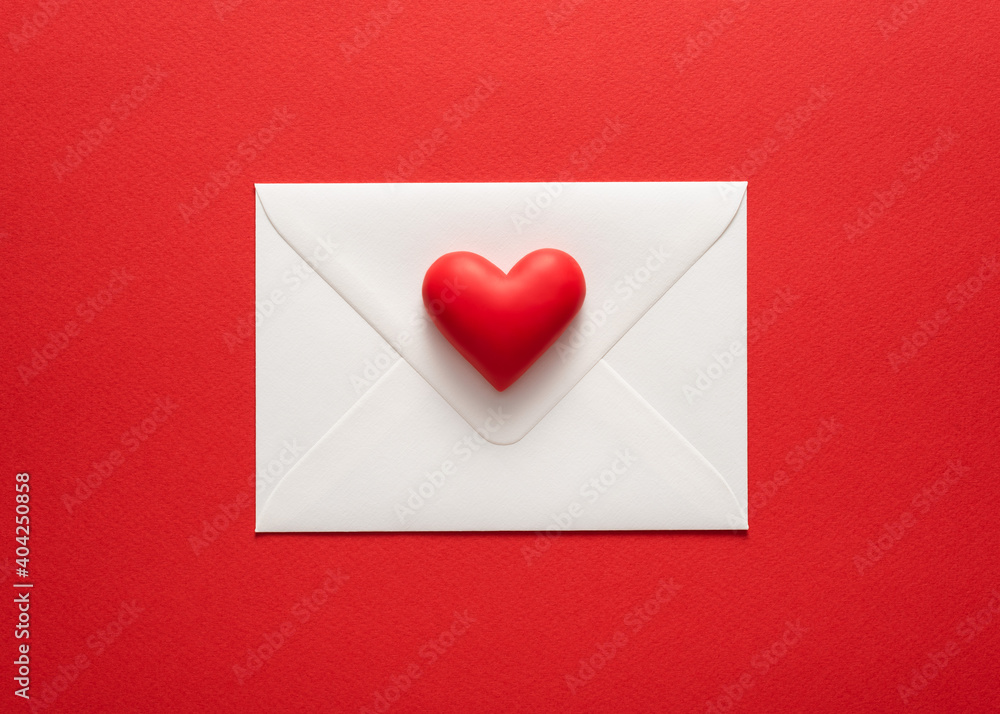 Minimalist valentines day card in red colors with heart on white envelope