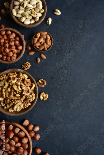Variety of nuts in a wooden bowl . Top view with copy space.
