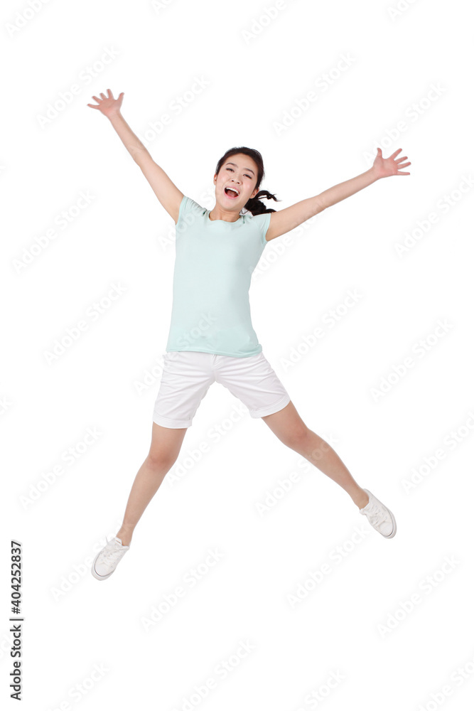 A happy Young woman in casual clothes jumping A happy Young woman in casual clothes jumping