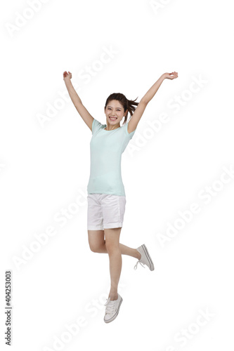 A young woman in casual dress jumped up 