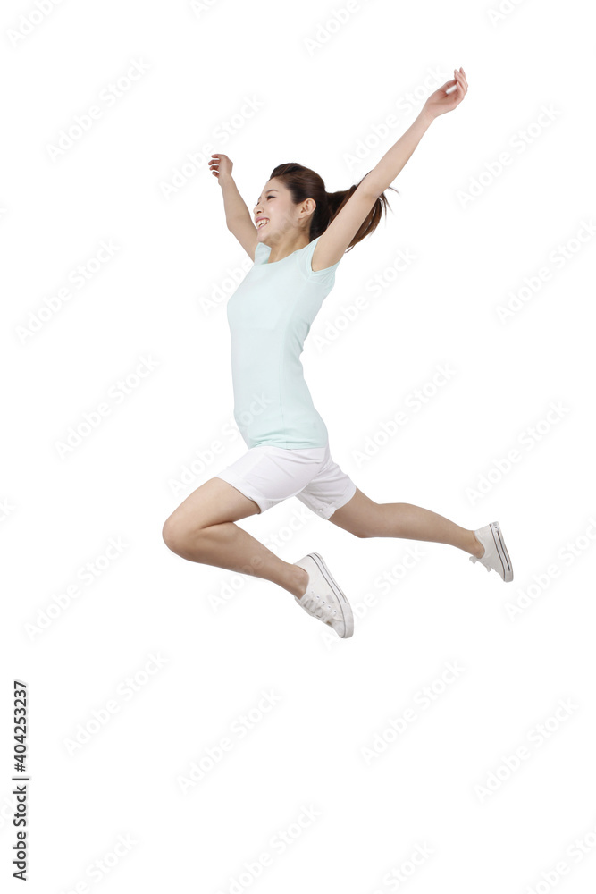 A young woman in casual dress jumped up 