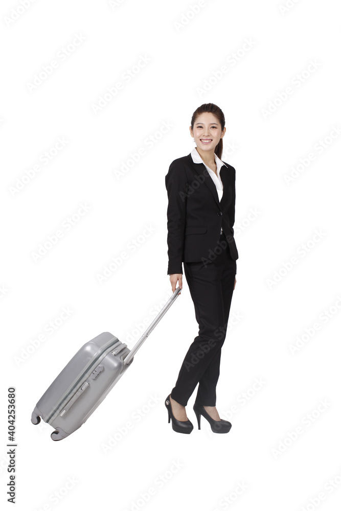 Business woman using cell phone pulling suitcase Business woman using cell phone pulling suitcase