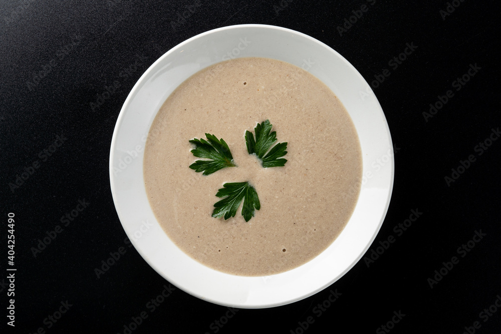 Minimalist and stylish photo for a restaurant menu: creamy mushroom soup with herbs Minimalist and stylish photo for a restaurant menu: creamy mushroom soup with herbs