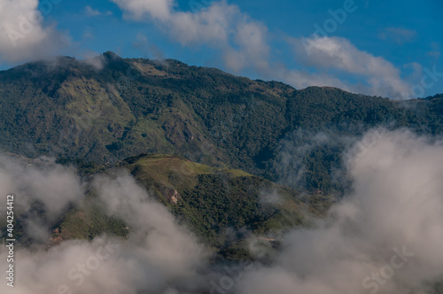  Colombian green mountains among the clouds at sunrise. Medellin, Colomia. January 10, 2021