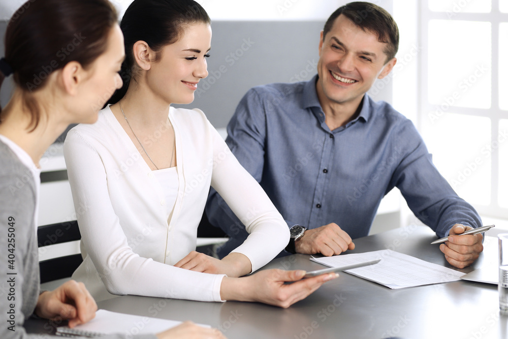 Group of business people discussing questions at meeting in modern office. Headshot at negotiation or workplace. Teamwork, partnership and business concept Group of business people discussing questions at meeting in modern office. Headshot at negotiation or workplace. Teamwork, partnership and business concept
