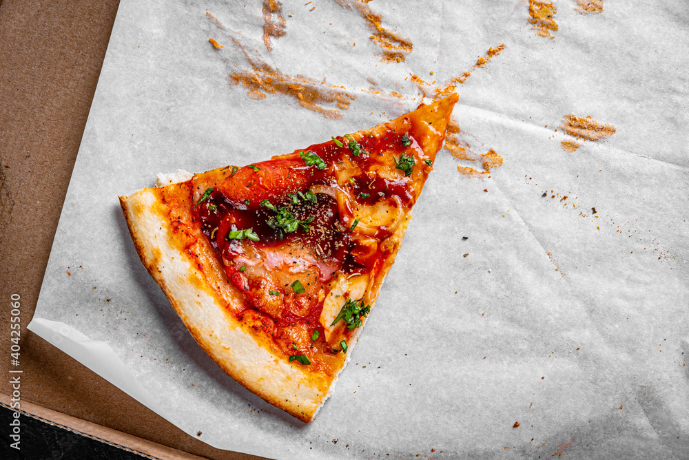 last one slice of Pizza with Mozzarella cheese, ham, bacon, Tomato sauce,  pepper, Spices and basil. Italian pizza in cardboard box Photos | Adobe  Stock