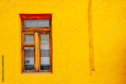 Wooden window of the old building on the background of the wall