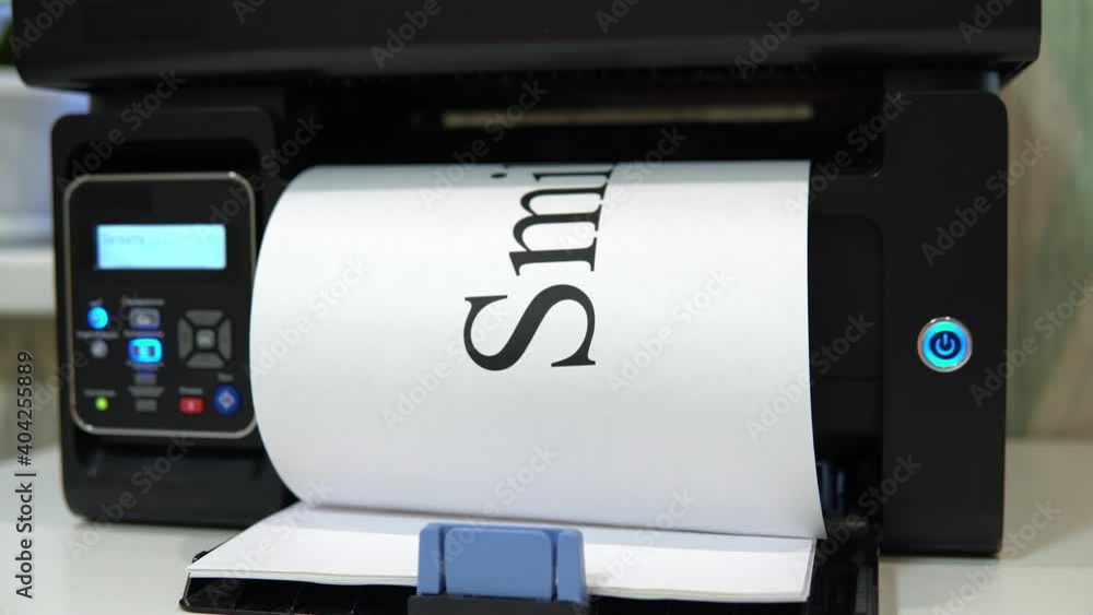 The printer on the table printed the word smile on a piece of paper The printer on the table printed the word smile on a piece of paper