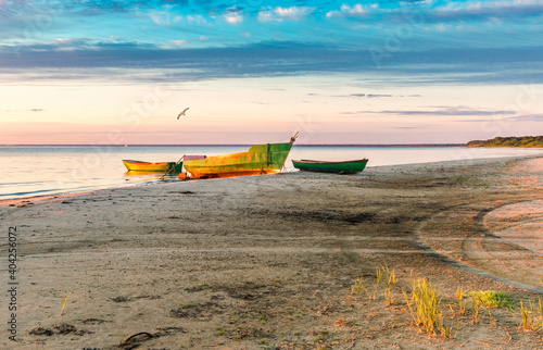 Anchored on sandy beach fishing boats near a small village of fishermen; here...