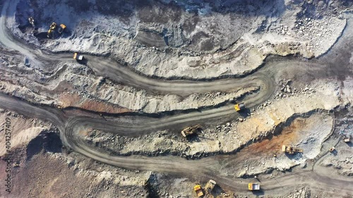 Belaz trucks driving in mine quarry, Ukraine. Aerial UHD 4K drone realtime video, shot in 10bit HLG and colorized