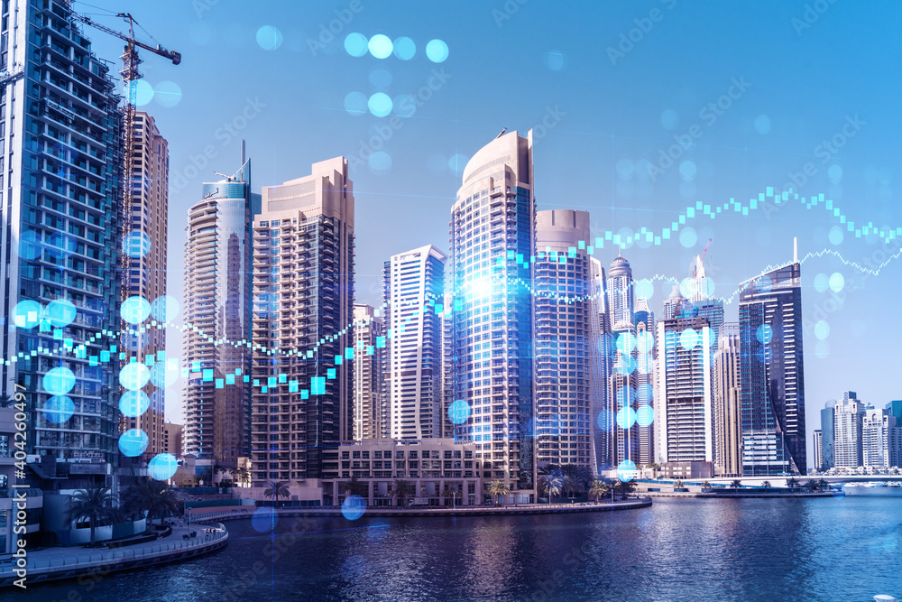 Fototapeta premium Skyscrapers of Dubai business downtown. International hub of trading and financial services of Western Asia. FOREX graph and chart concept. Double exposure. Dubai Canal waterfront.