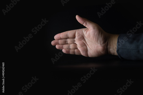 Businessman stretches out his hand.