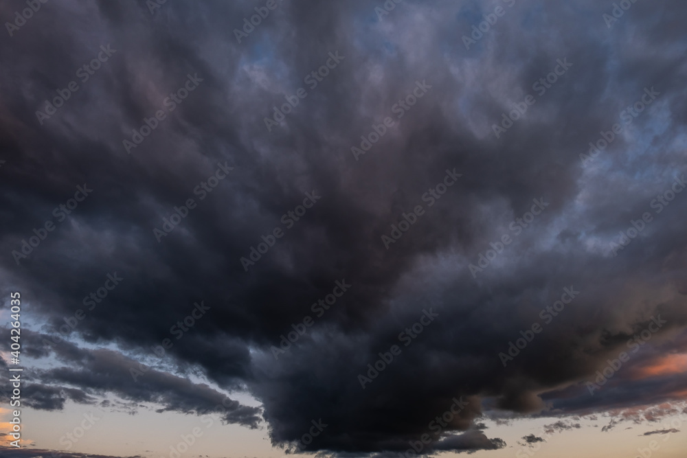 Obraz premium Dark ominous gray thundercloud. Dramatic sky. Atmospheric environment and climate weather background. Space for text.