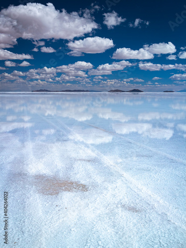 A road made of salt in sky while a sea of clouds is reflected in Earth's mirror, Uyuni salt flat, Bolivia